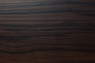 Dark brown plastic with black stripes, background.