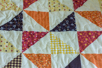 Patchwork. A fragment of a patchwork quilt as a background. Colored patchwork quilt.