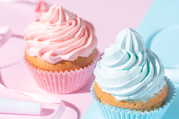gender party. boy or girl. two cupcakes with blue and pink cream, celebration concept when the gender of the child becomes known