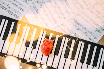 Heart on piano toy with bokeh Christmas lights effect 