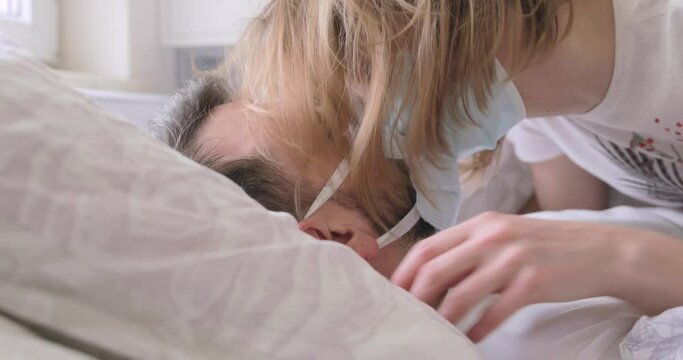 A silly couple kissing with their masks still on, during a pandemic.