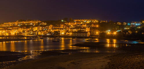 Fototapeta na wymiar Paisaje panorámico nocturno de San Vicente de la Barquera en Cantabria, España. Bañada por el mar Atlántico, en el verano de 2020