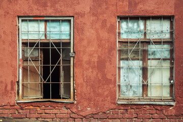 Fototapeta na wymiar Two retro textured windows and a long-painted brick wall (fragments)
