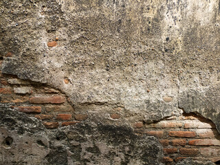 old walls that have started to peel off and look red bricks.