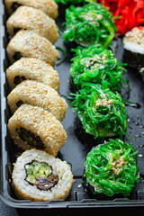 sushi rolls set salmon, rice, tuna, nori wakame tobiko caviar fresh snack ready to eat on the table meal snack ingredient top view copy space for text food background rustic image