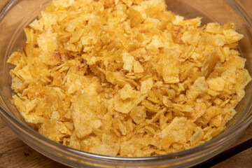 A bowl of crunched potato chips, crisps used for cooking