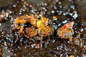 Burnt pan with oil. Fat leftovers close up. Unhealthy food. Damaged kitchenware.