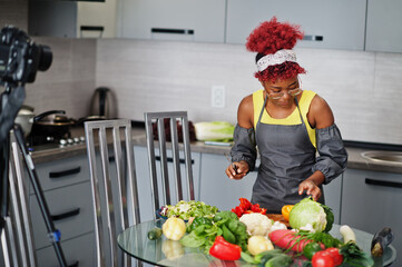African american woman filming her blog broadcast about healthy food at home kitchen.