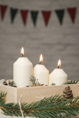 Wooden box christmas centerpiece. Simple and small home decoration with candles in wooden box.
