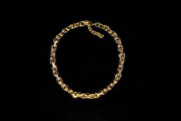 Golden jewelry chain isolated on black background