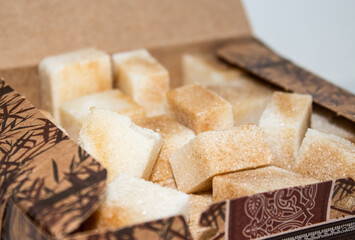 Reed sugar in the form of cubes in a cardboard box