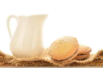 Shortbread biscotti with white ceramic dishes, close-up, on a white background.