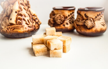 Cubes of brown cane sugar against the backdrop of a beautiful service