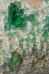 Glass crystals grow on stone. Transparent and green. The concept of minerals, bijouterie.