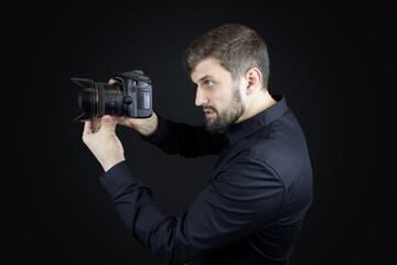 Fototapeta premium male photographer looks at digital camera display