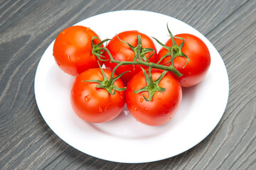 Fresh red tomato on a plate. Vitamin vegetable food