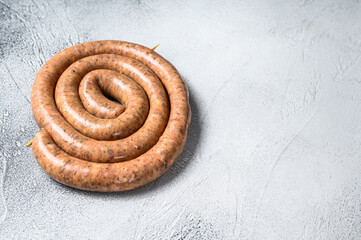 Fototapeta na wymiar Raw spiral sausage from pork and beef mince meat. White background. Top view. Copy space