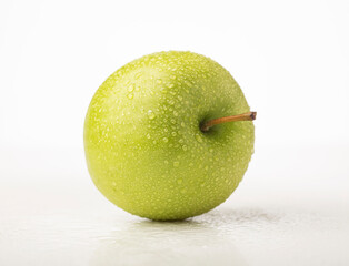 Water drops on green apple isolated on white