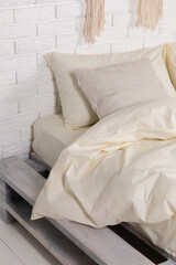 Bed on a pallet. An interesting decorated room.