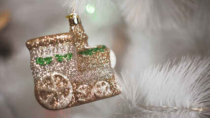 christmas shiny toy steam locomotive on white christmas tree. bright christmas and new year background in horizontal orientation 