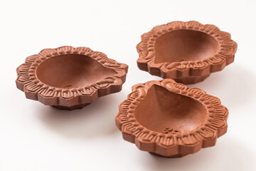 Empty Terracotta oil lamp on white background.