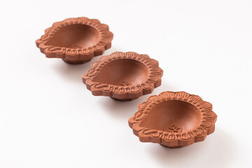 Empty Terracotta oil lamp on white background.