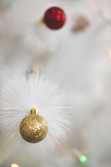 christmas and new year background with white christmas tree and golden glitter ball