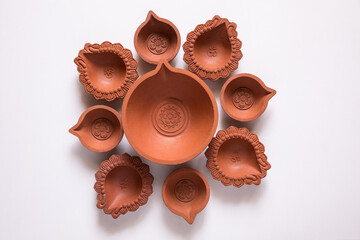 Empty Terracotta oil lamp on white background.