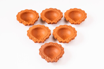 Empty Terracotta oil lamp on white background.