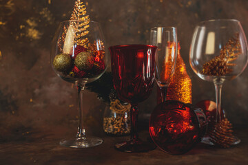 new year and christmas background with different glasses and toys for the christmas tree on a dark background