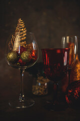 new year and christmas background with different glasses and toys for the christmas tree on a dark background