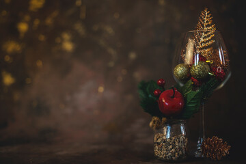 new year and christmas background with different glasses and toys for the christmas tree on a dark background