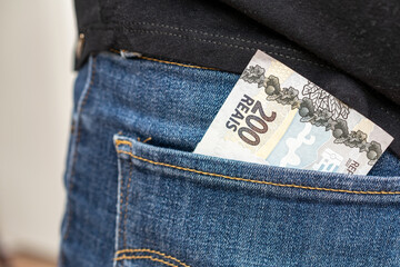 Brazilian money in jeans pocket