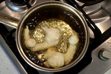 SFINCI Traditional Sicilian Italian Fried Doughnuts while frying in vegetable oil