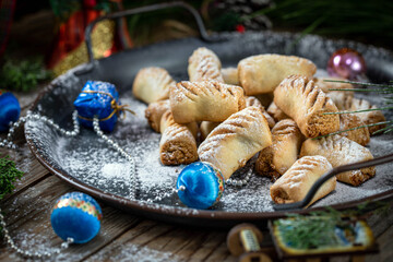 Peanut-filled cookies. Festive cookies for the new year, against the background of a Christmas tree and garlands