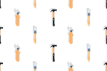 Tools seamless pattern. Tools: construction brushes, hammer, wrench on a white background.