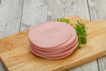 Sliced pork natural sausages over board