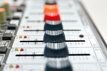 The faders are all open right on the mixing console, close-up.
