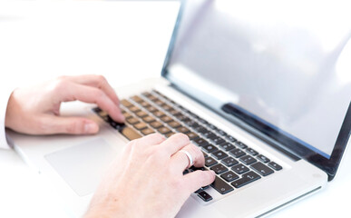 Fototapeta na wymiar Close hands of married boy working on modern laptop