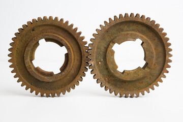 Rusty gears from an old mechanism on a white background, photographed up close.