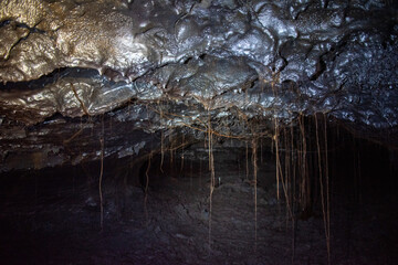 Underground volcanic cave exploration in Reunion island , speleology tourism, France.