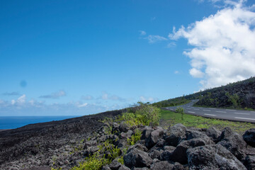 Volcanic and sea landscape with a road on the flanks of the Piton de la Fournaise in Réunion...