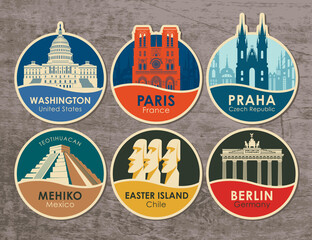 Set of stickers with the sights of the capitals of various countries. Vector illustration on travel theme with round emblems on a wooden background. USA, France, Czech Republic, Mexico, Chile, Germany © paseven
