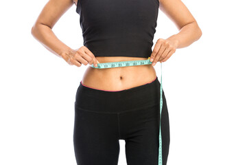 Fit woman measuring her waist over a white background