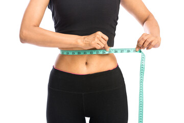 Fit woman measuring her waist over a white background