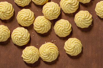An overhead photo of chocolate chips cookies, shot from above on a piece of baking paper, with copy space