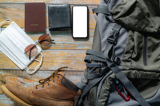 Protecting COVID-19 while Traveling. Travel accessories costumes. Passports, luggage, The cost of travel maps prepared for the trip .concept new normal lifestyle