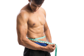 Fit man measuring his waist with tape measure, isolated on white background