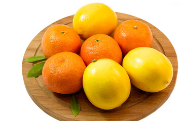 Fresh tangerines and lemons on a wooden cutting kitchen board, isolate on a white background.
