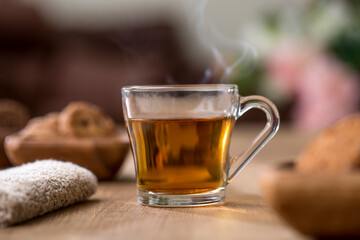 Organic Lemon Green tea in Transparent cup at table near window